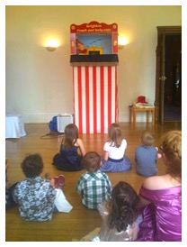 children watching a punch and judy show